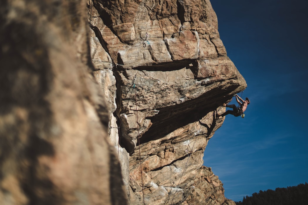 man climbing a rock
