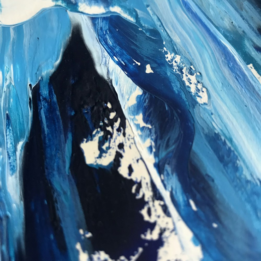 a close up of a blue and white abstract painting