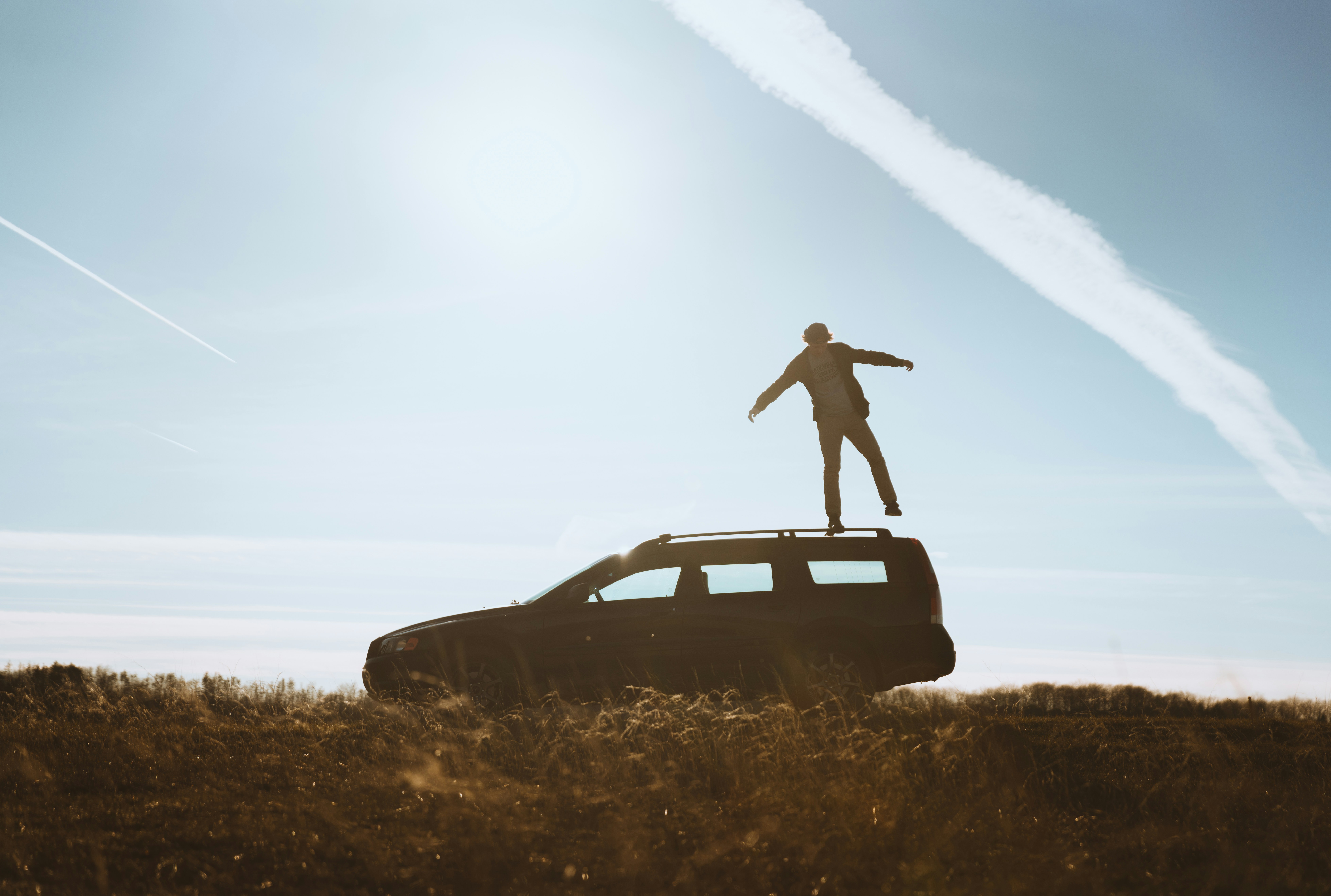 man standing on car