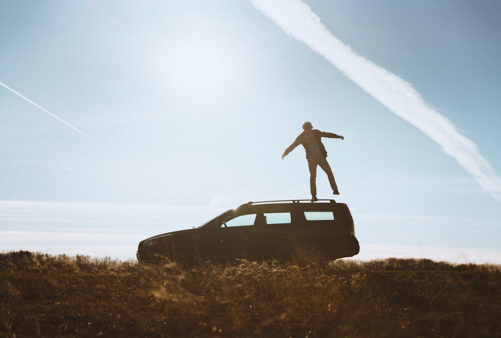 man standing on car