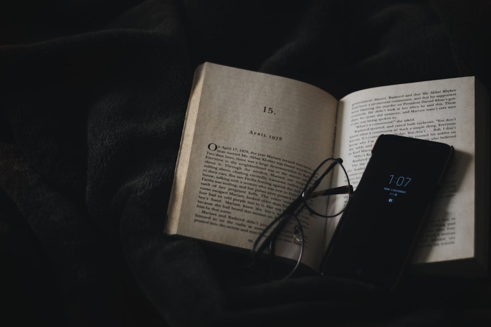 black smartphone on book