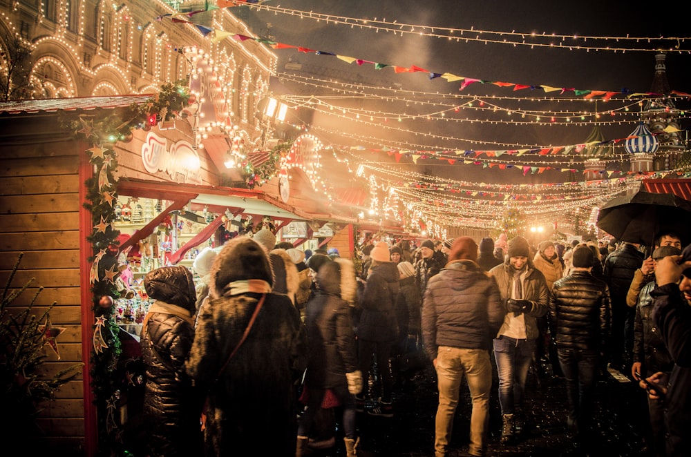 group of people standing near amusement park