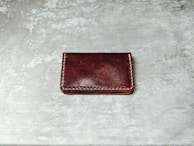 Close-up of a leather wallet showing detailed stitching and natural textures.