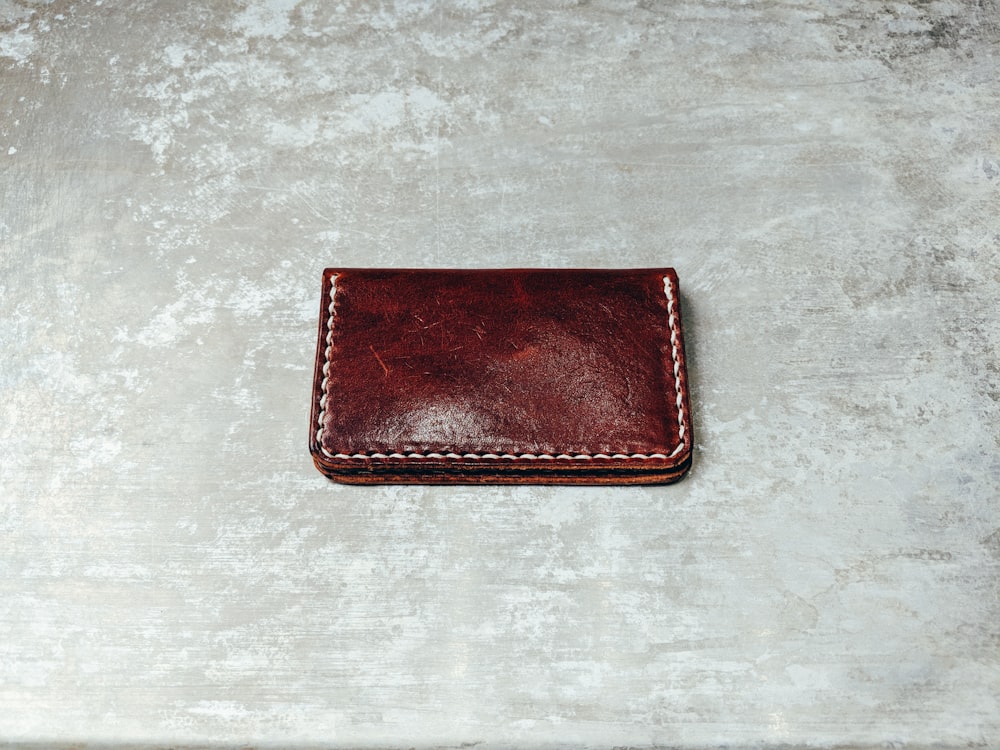 photo of brown leather bifold wallet