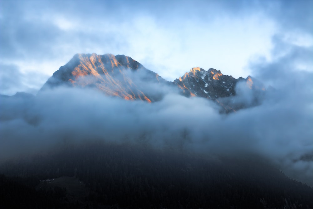 time-lapse photography of mountain surrounded by cloudes