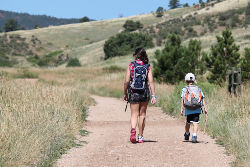 woman walking beside holding walking while holding stick