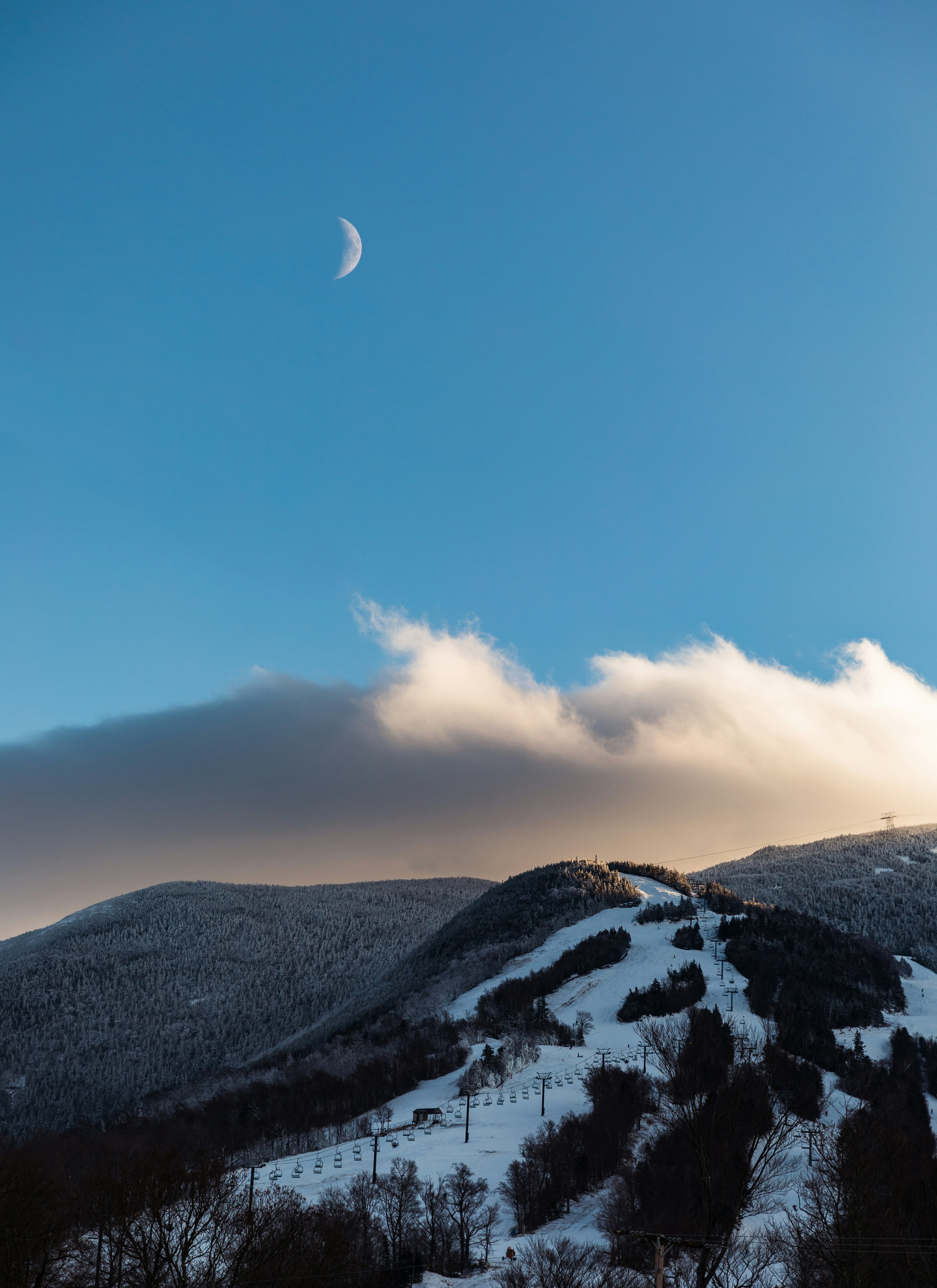 snow and plant covered mountain under crescent moon during daytime
