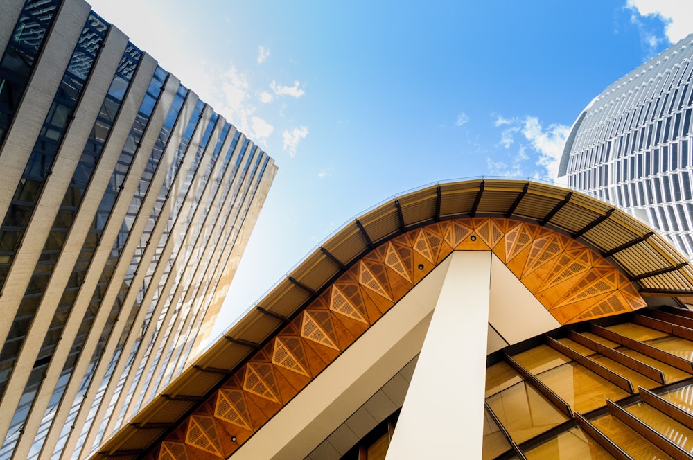 low angle photography of building under white and blue skies