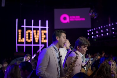 three man band playing on stage at night