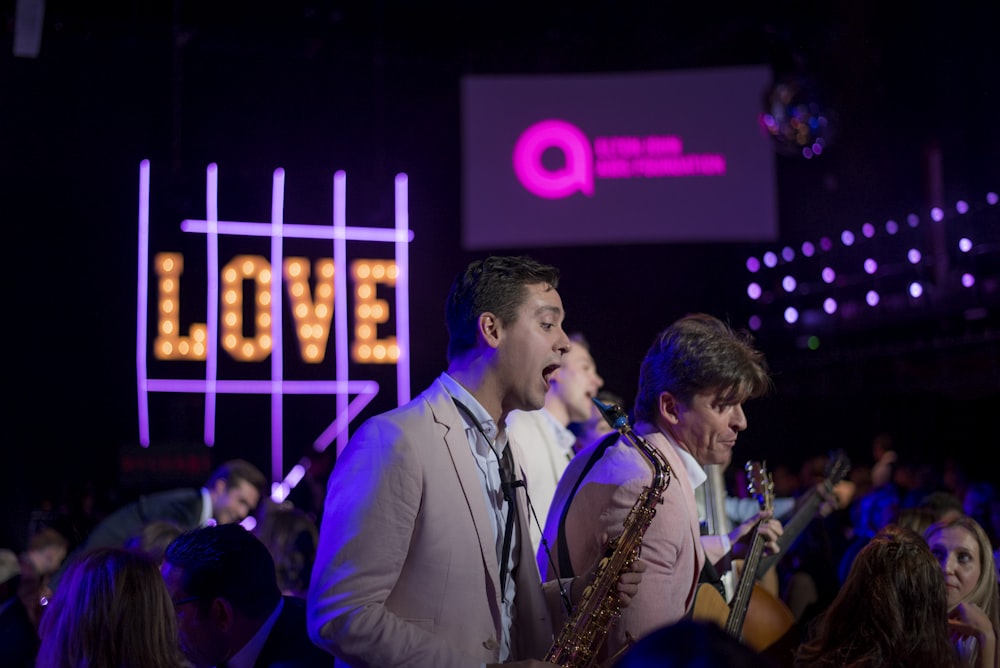 three man band playing on stage at night