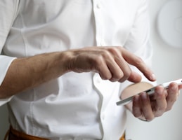 person holding white Android smartphone in white shirt