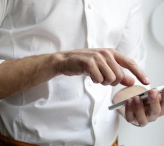 person holding white Android smartphone in white shirt