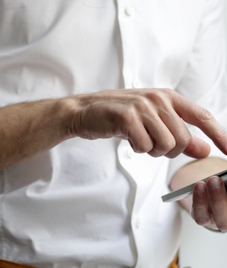 person holding white Android smartphone in white shirt