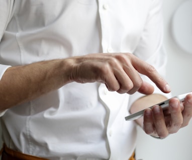 person holding white Android smartphone in white shirt