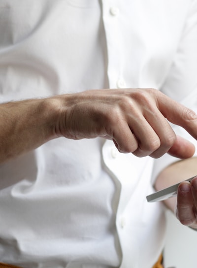 person holding white Android smartphone in white shirt