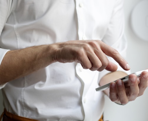 person holding white Android smartphone in white shirt