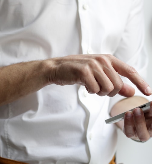 person holding white Android smartphone in white shirt