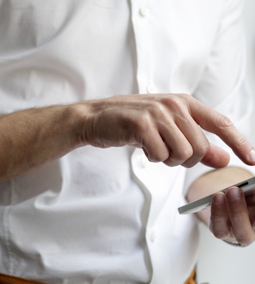 person holding white Android smartphone in white shirt