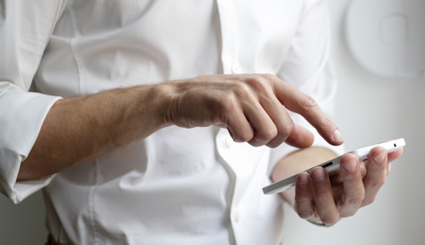 person holding white Android smartphone in white shirt