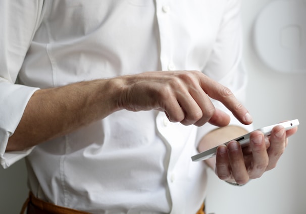 person holding white Android smartphone in white shirt