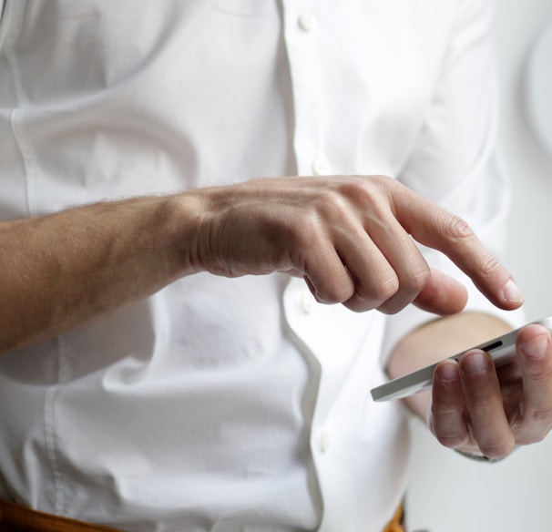 person holding white Android smartphone in white shirt