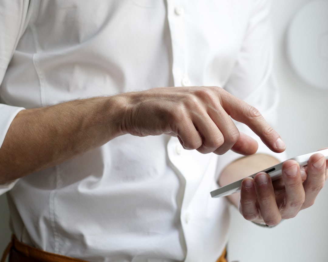 person holding white Android smartphone in white shirt