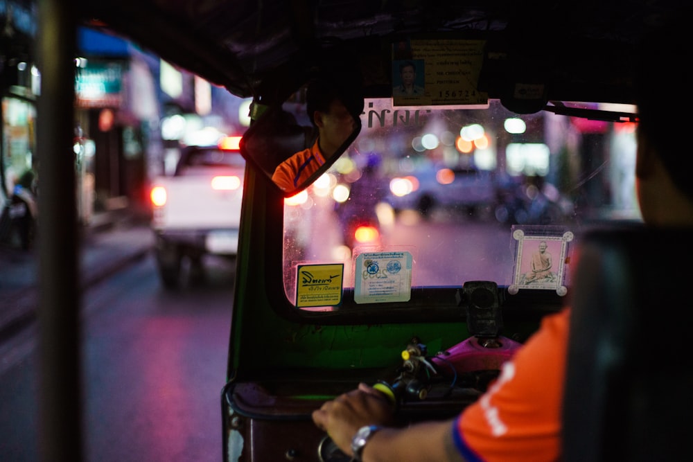 man sitting on vehicle