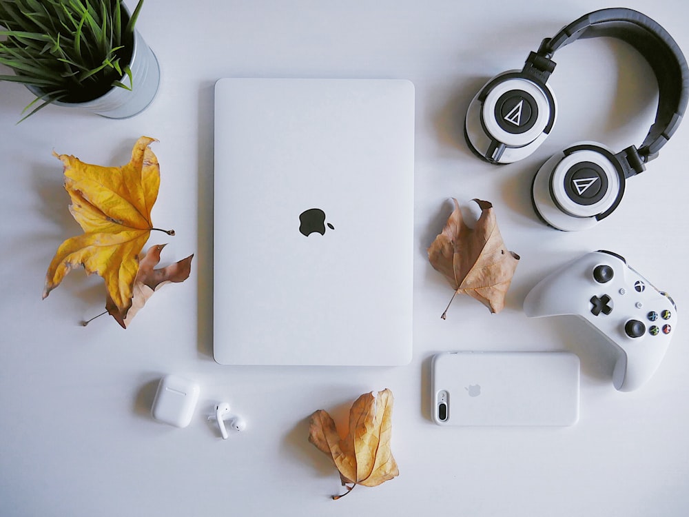 MacBook beside headphones