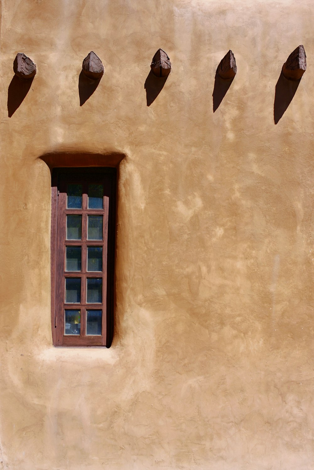 closed window with brown wall paint