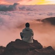 man sitting on cliff