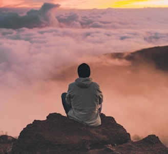 man sitting on cliff