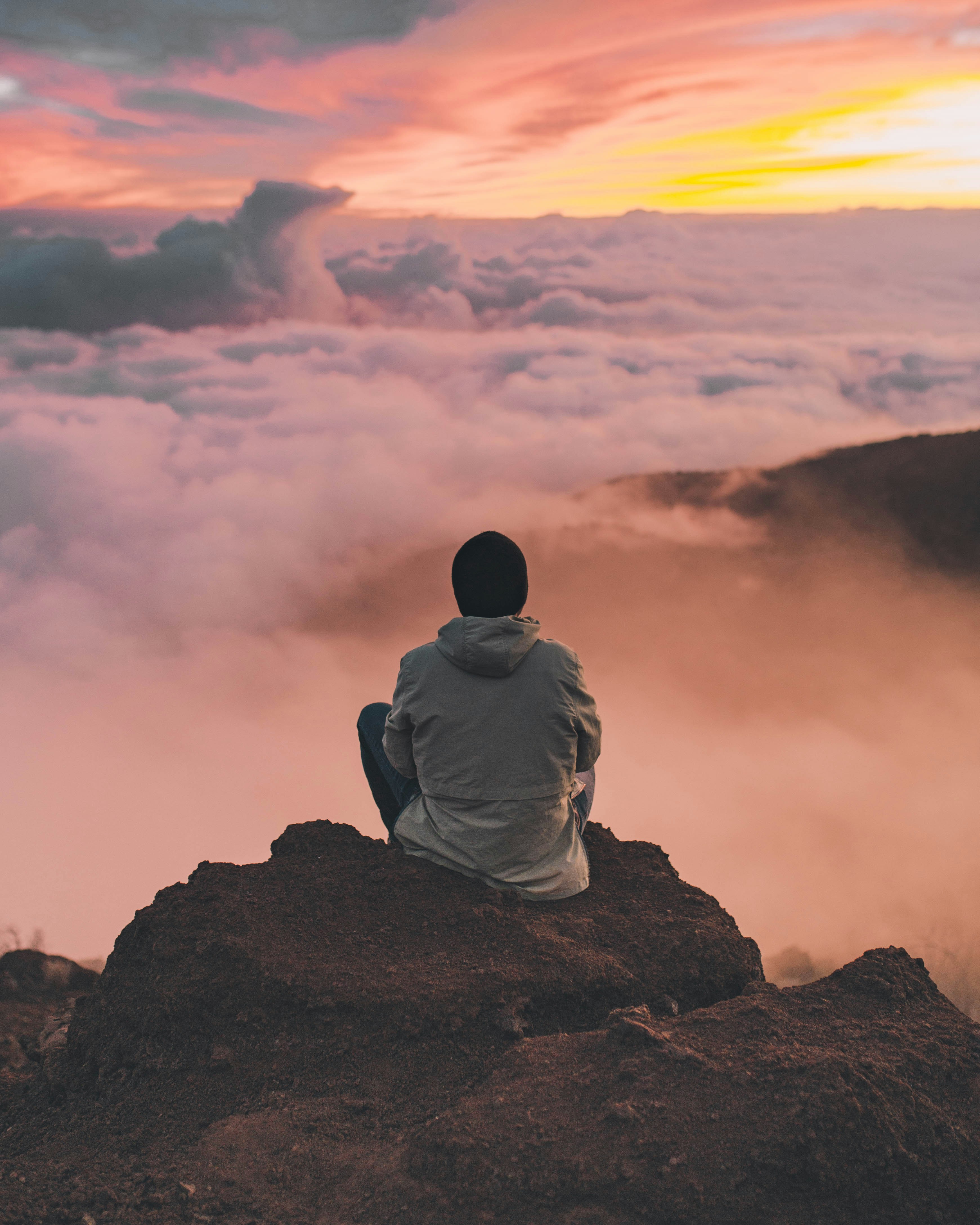 great photo recipe,how to photograph i traveled to the top of mauna kea one of the largest mountains in the world, although most of the mountain lies under water.  the clouds surrounded my view point and it felt like i was entering into heaven.; man sitting on cliff