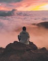 man sitting on cliff