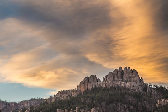 gray mountain under brown and blue sky during daytime in Black Elk Wilderness United States