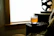 A cozy corner of Jungle Amber with amber-lit wooden tables and a glass of craft beer catching the warm glow.