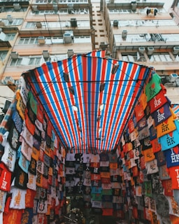 assorted T-shirts under red and blue awning