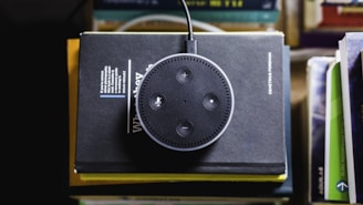 black Amazon Echo on black covered book