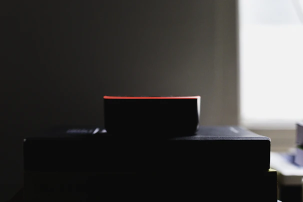 A smart home device glowing softly on a cozy living room shelf at dusk.