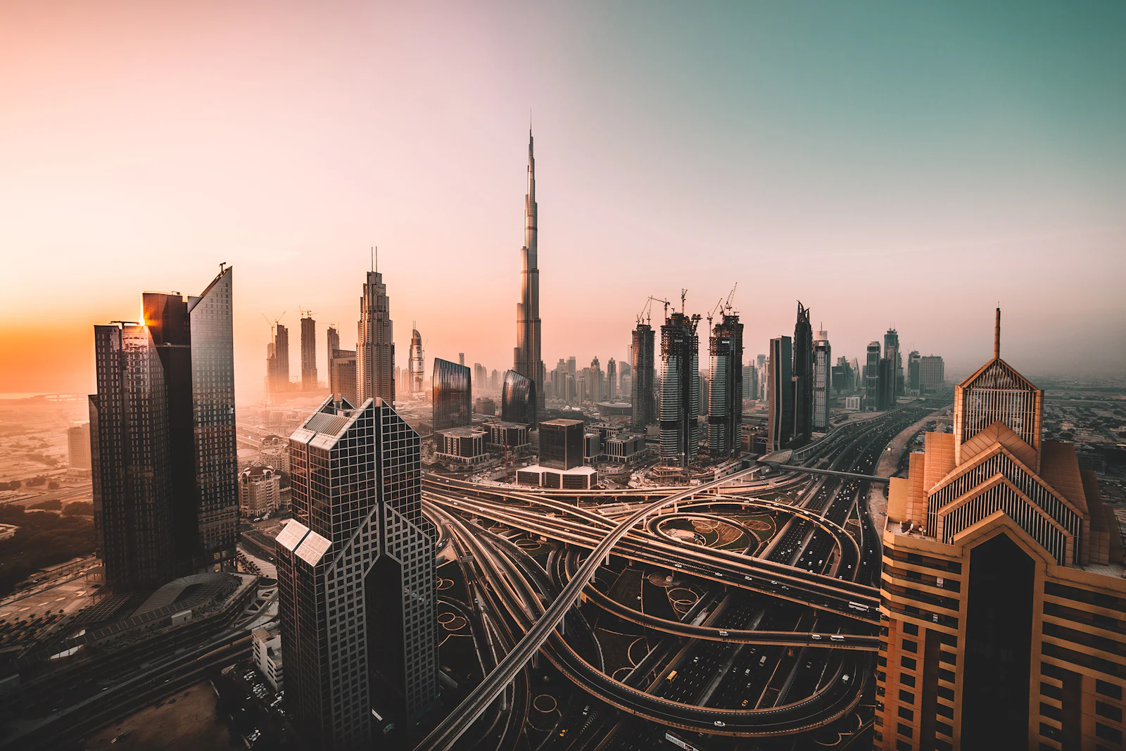 Dubai's towers and looping motorway interchanges at sunrise