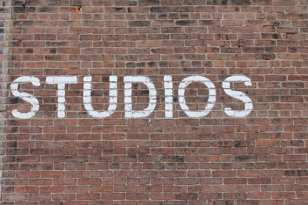 Studios text on brown brick wall