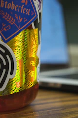 Close-up of colorful custom stickers applied on a laptop and water bottle.