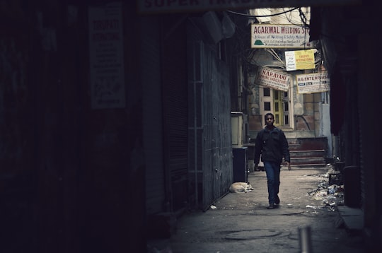 man walking in the street during daytime in New Delhi India