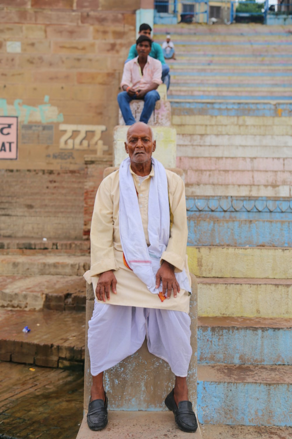 men sitting on stairs at daytime