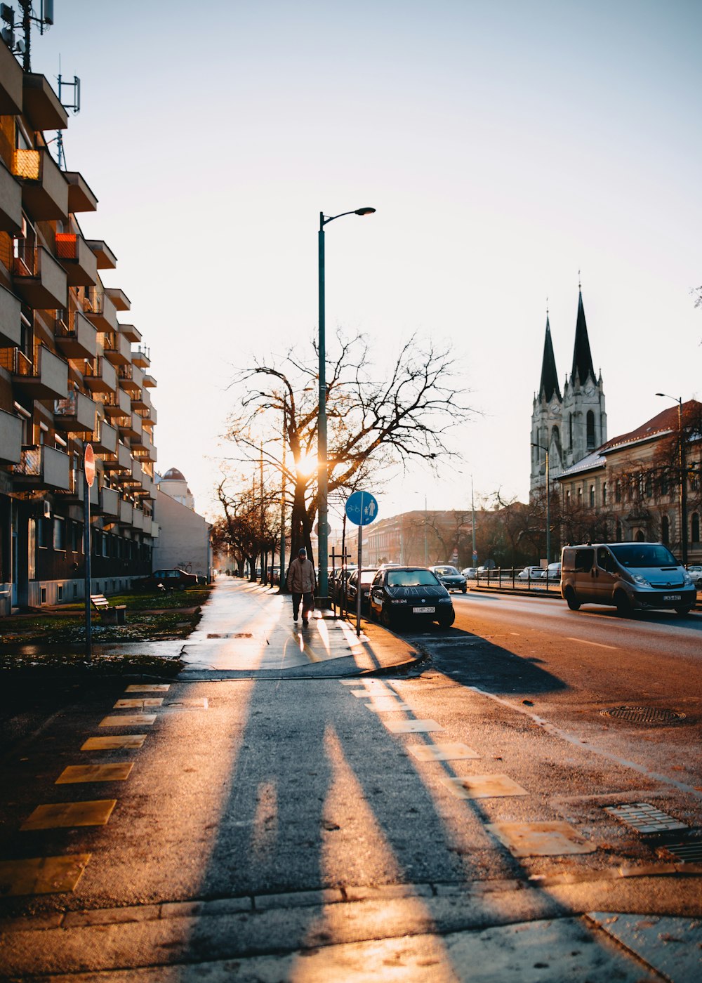 man walking on road in front of building