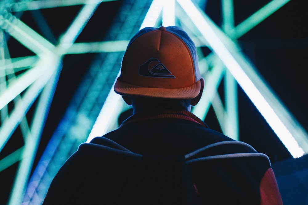 selective focus photograph of person wearing cap and jacket