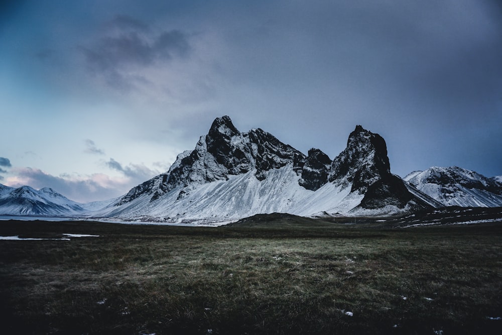 mountain alp under cloudy sky