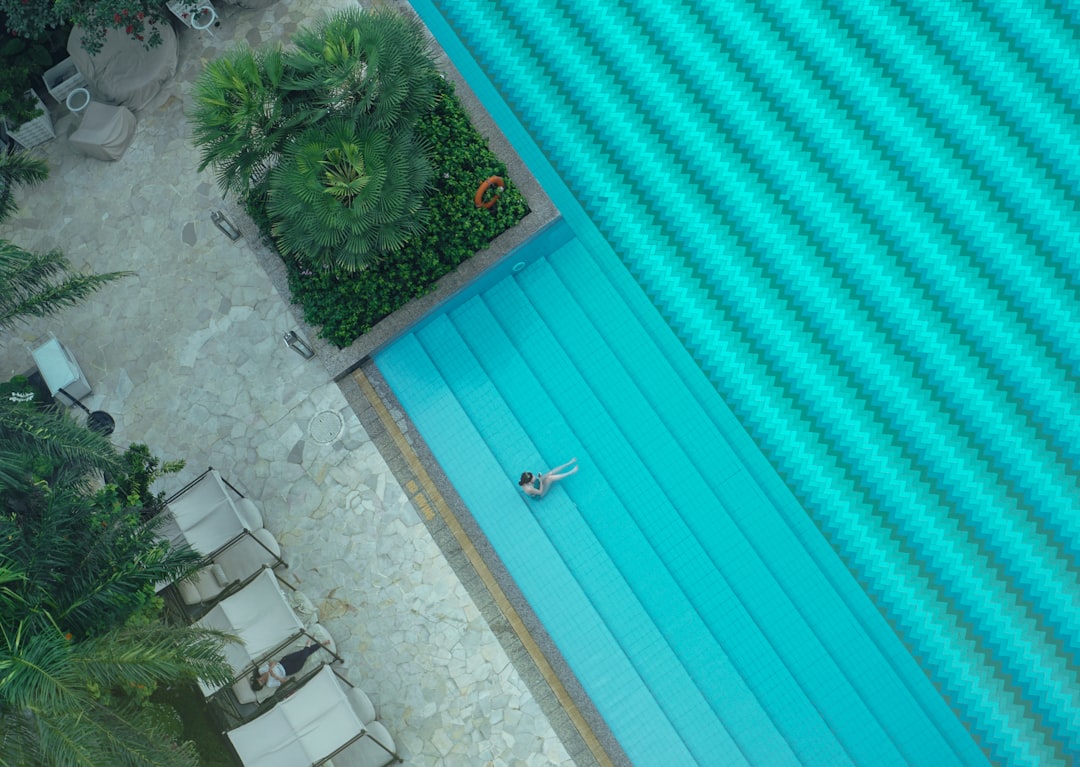 person sitting on teal surface
