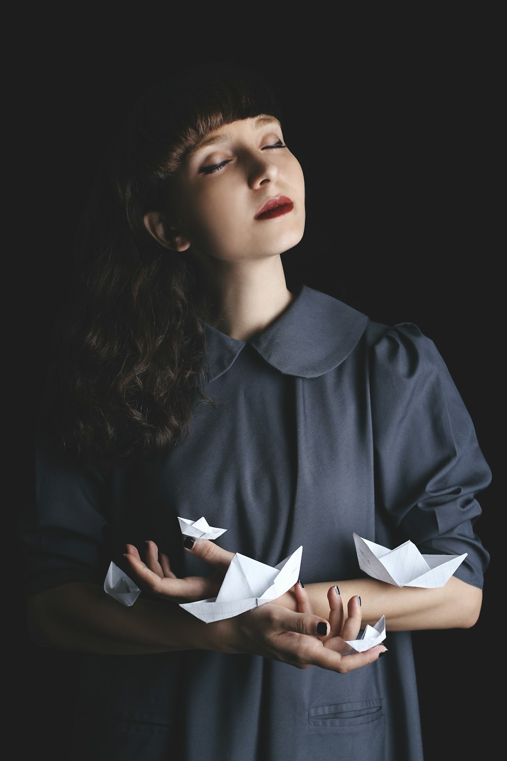 woman holding paper boat