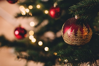 shallow focus photography of red bauble on christmas tree