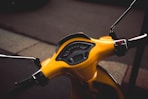 photo of yellow motor scooter